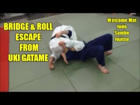 BRIDGE AND ROLL ESCAPE FROM UKI GATAME (KNEE ON BELLY)
