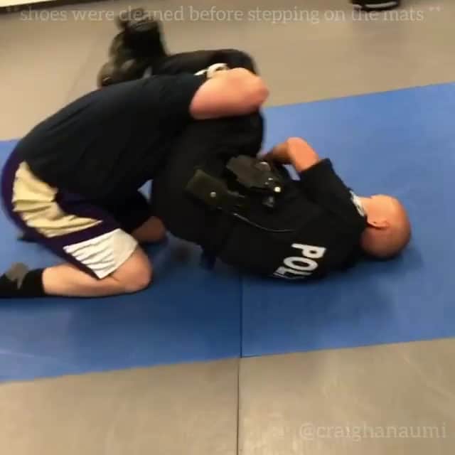Brazilian Jiu Jitsu rolling in a Police uniform