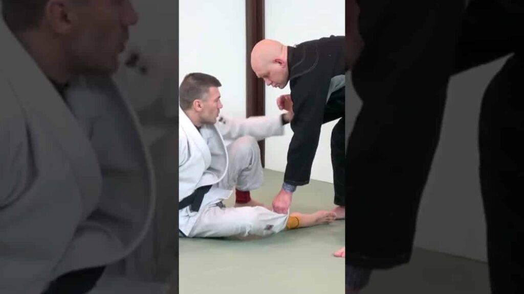 If he controls your leg then get a lapel grip. This counters him and allows you to drag him hard!
