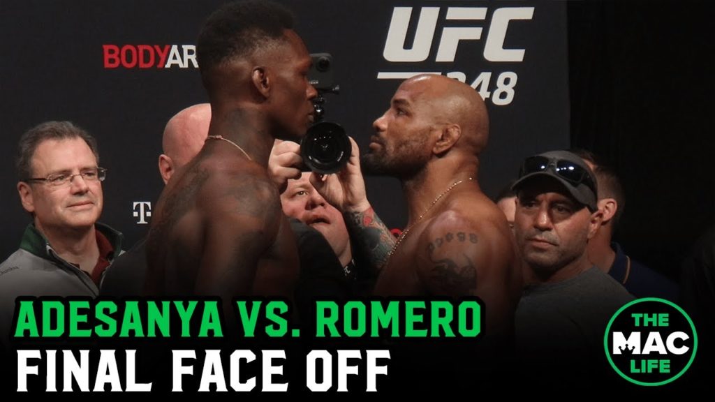 Israel Adesanya and Yoel Romero have intense final staredown as Adesanya smokes a Cuban cigar