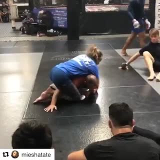 Miesha Tate shows a guillotine from crucifix