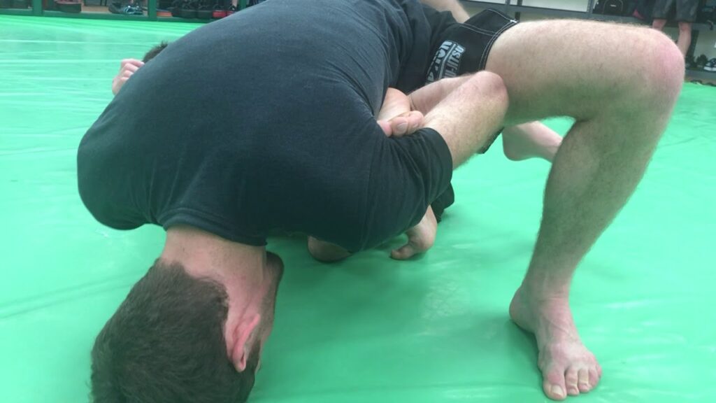 Stepping inside double butterfly hooks, belly-down straight ankle lock